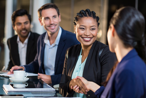 Businesswoman,Shaking,Hands,With,Colleague,In,The,Office